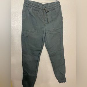Olive green joggers, elastic at the ankle and waist